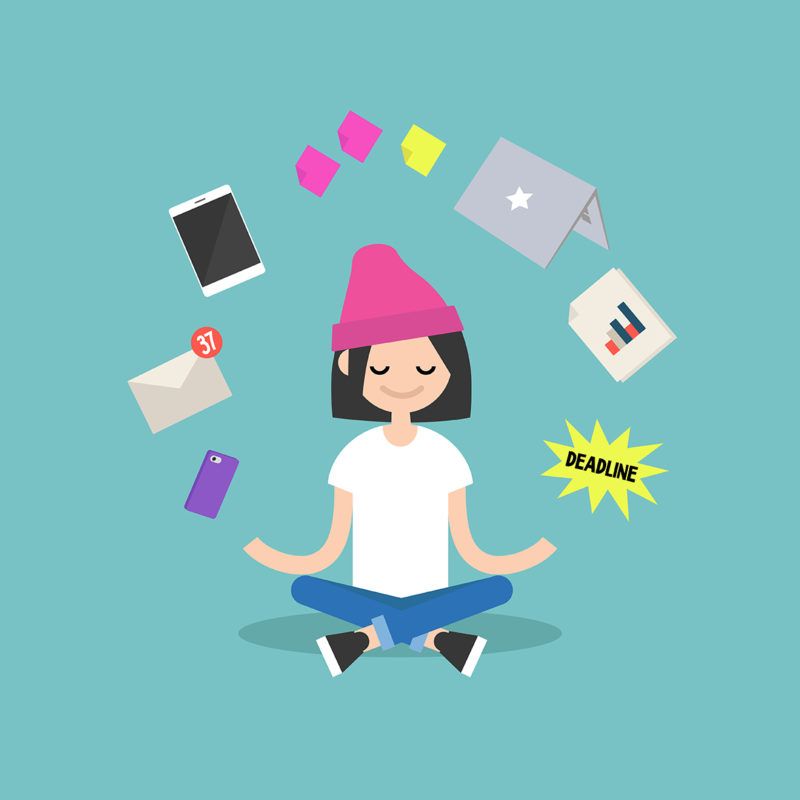 Female employee meditating and balancing all of her tasks